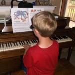 Isaac practicing for his next piano lesson
